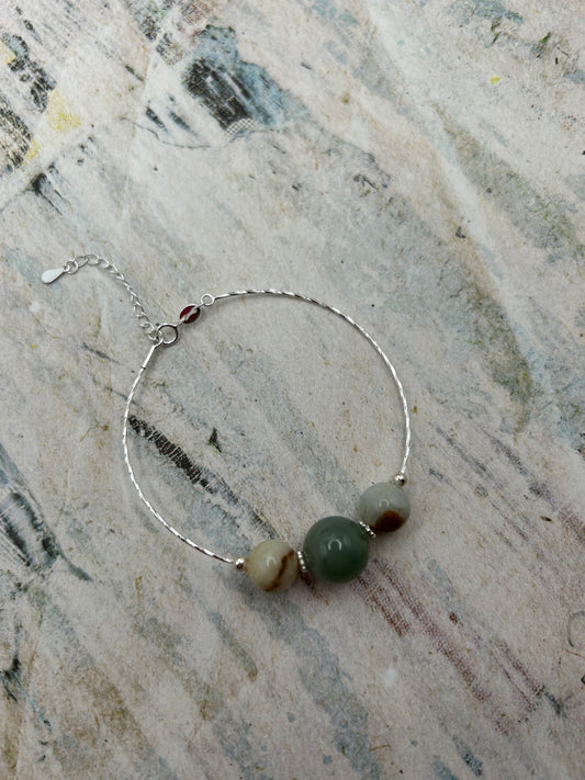 Grade A Natural Green and Beige Burmese Jadeite beads on a sterling silver bracelet