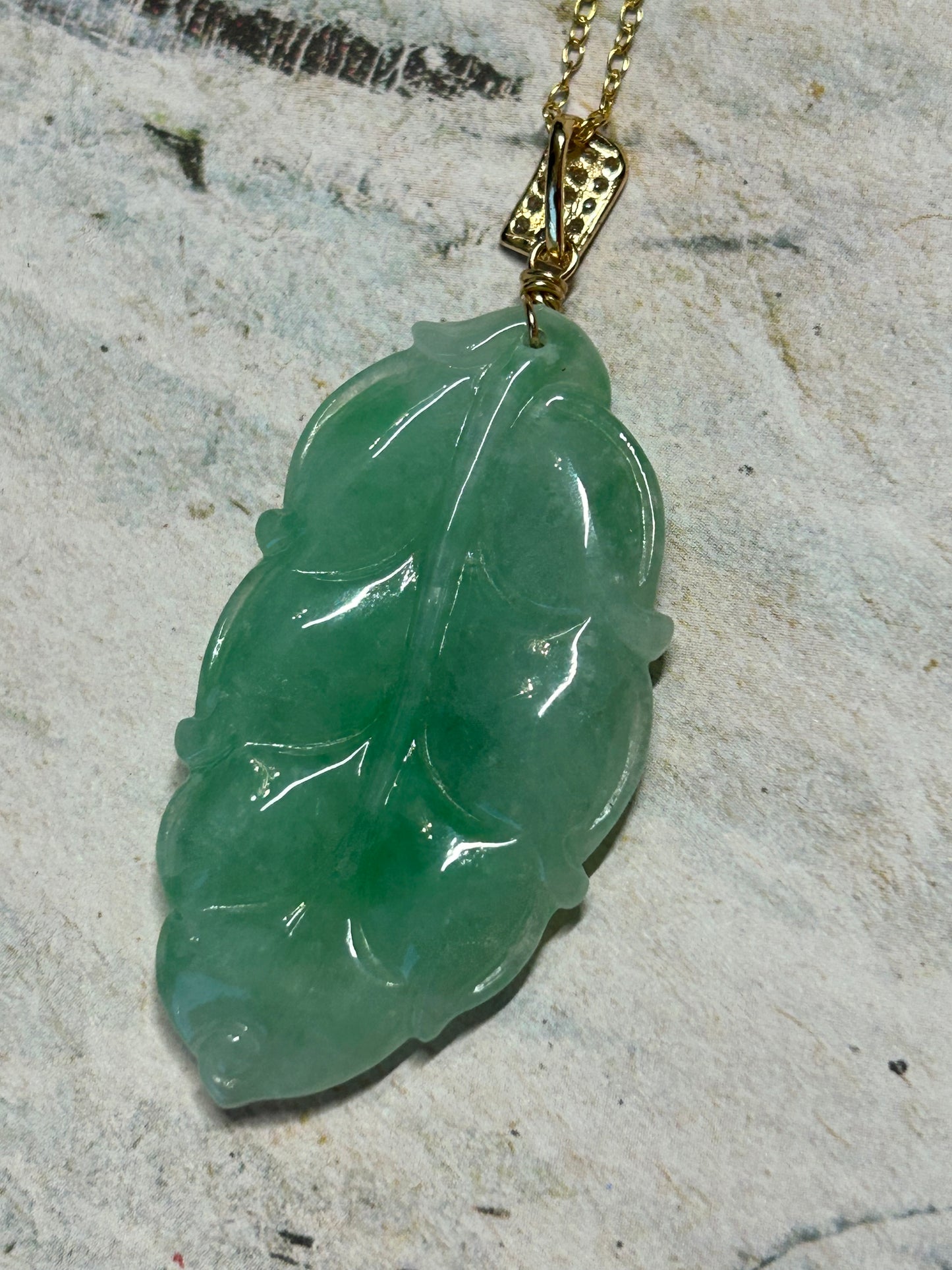 Grade A Natural Icy green Burma Jadeite pendant with double sided hand carved with leaf gold over sterling silver bail pendant