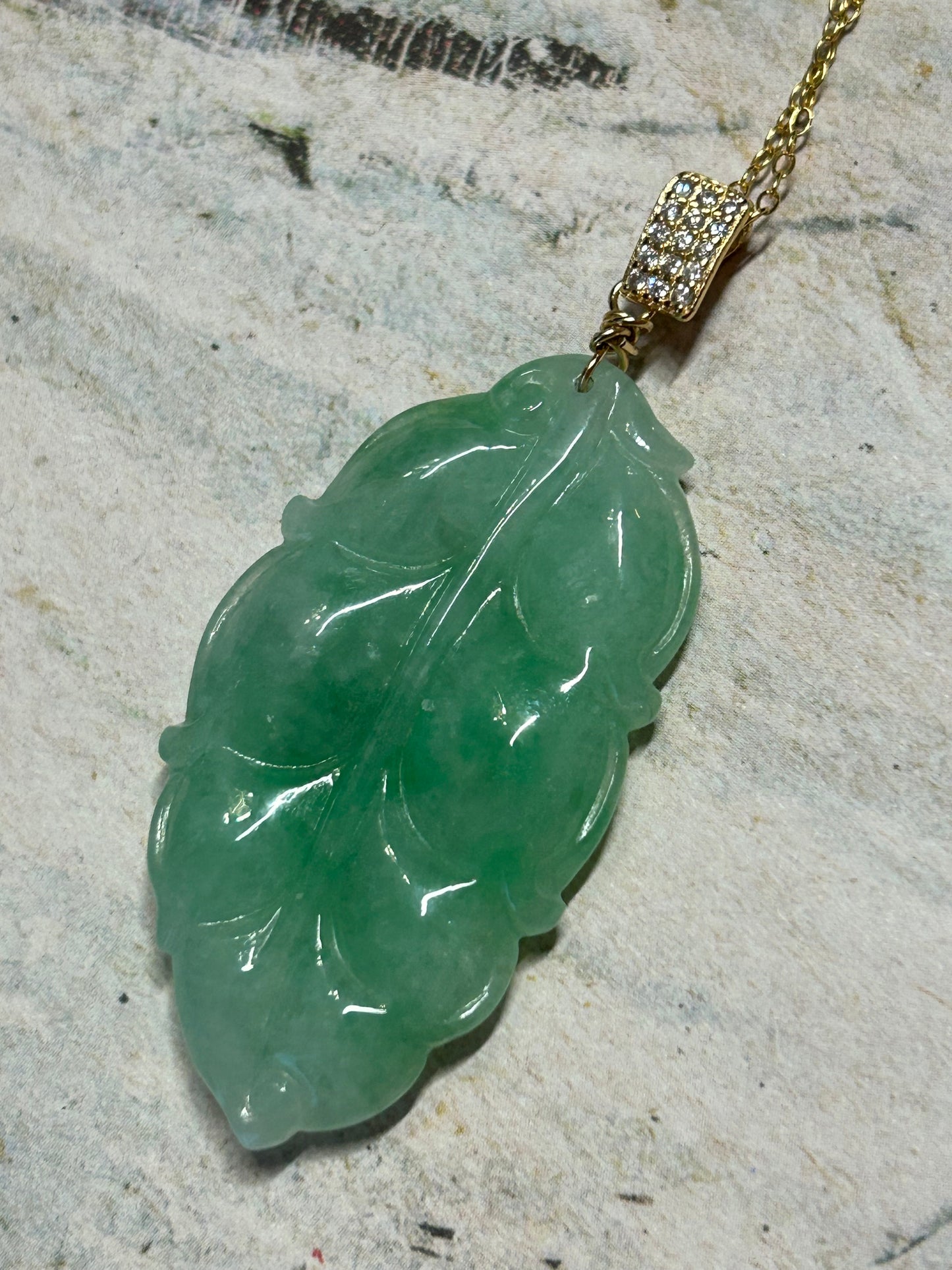 Grade A Natural Icy green Burma Jadeite pendant with double sided hand carved with leaf gold over sterling silver bail pendant