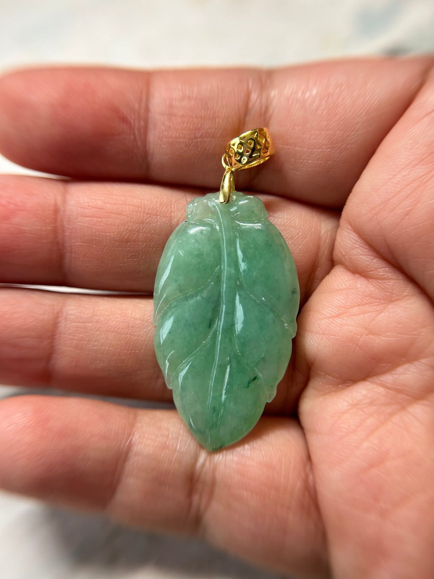 Grade A Natural Icy green Burma Jadeite pendant with double sided hand carved with leaf gold over sterling silver bail pendant