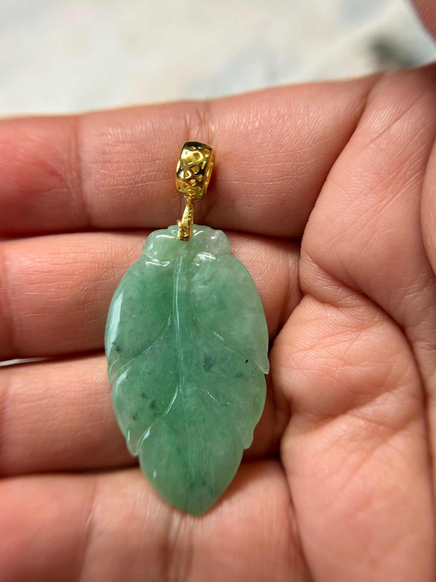 Grade A Natural Icy green Burma Jadeite pendant with double sided hand carved with leaf gold over sterling silver bail pendant