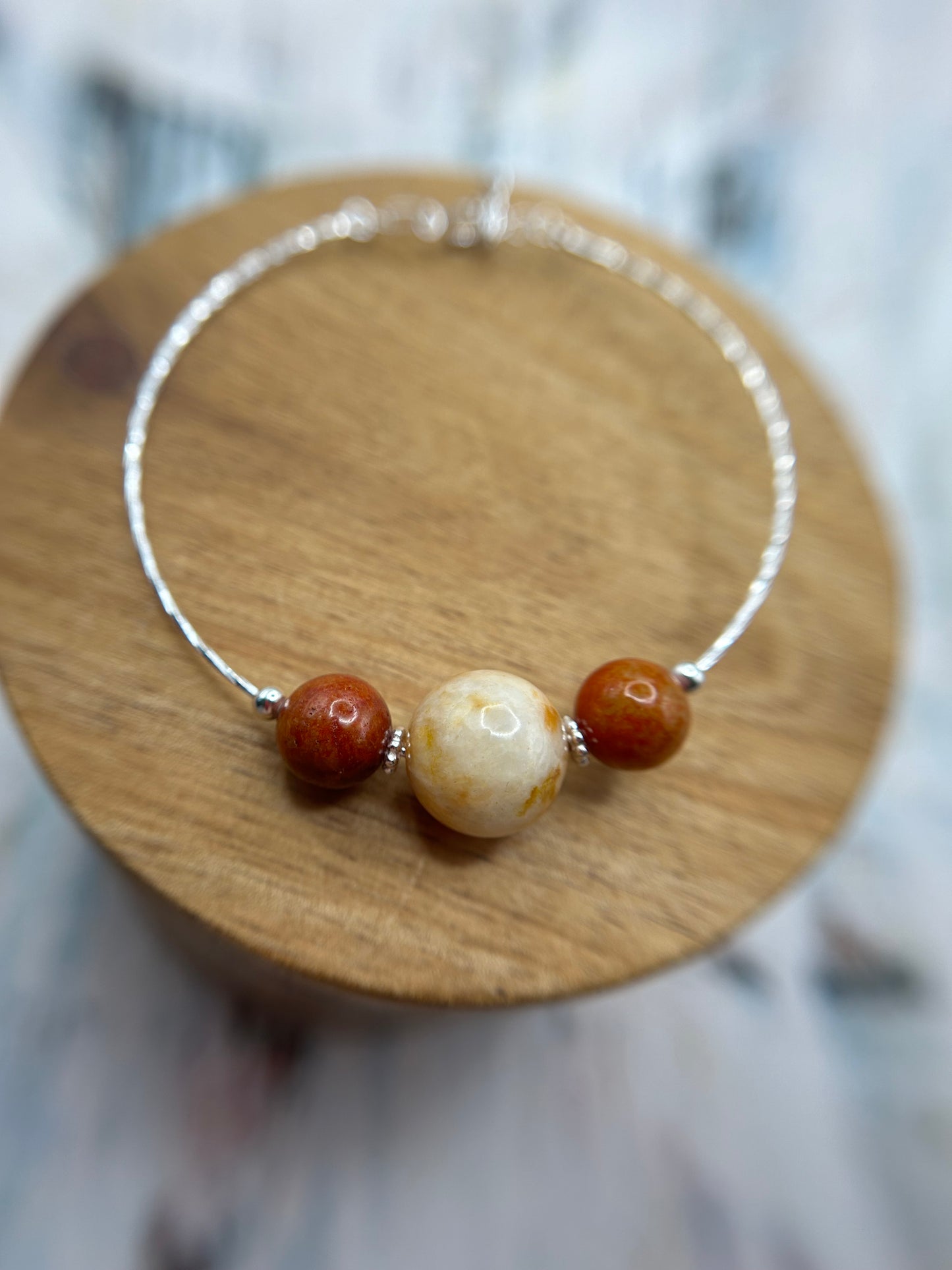 Grade A Natural Beige and Red Burmese Jadeite beads on a sterling silver bracelet