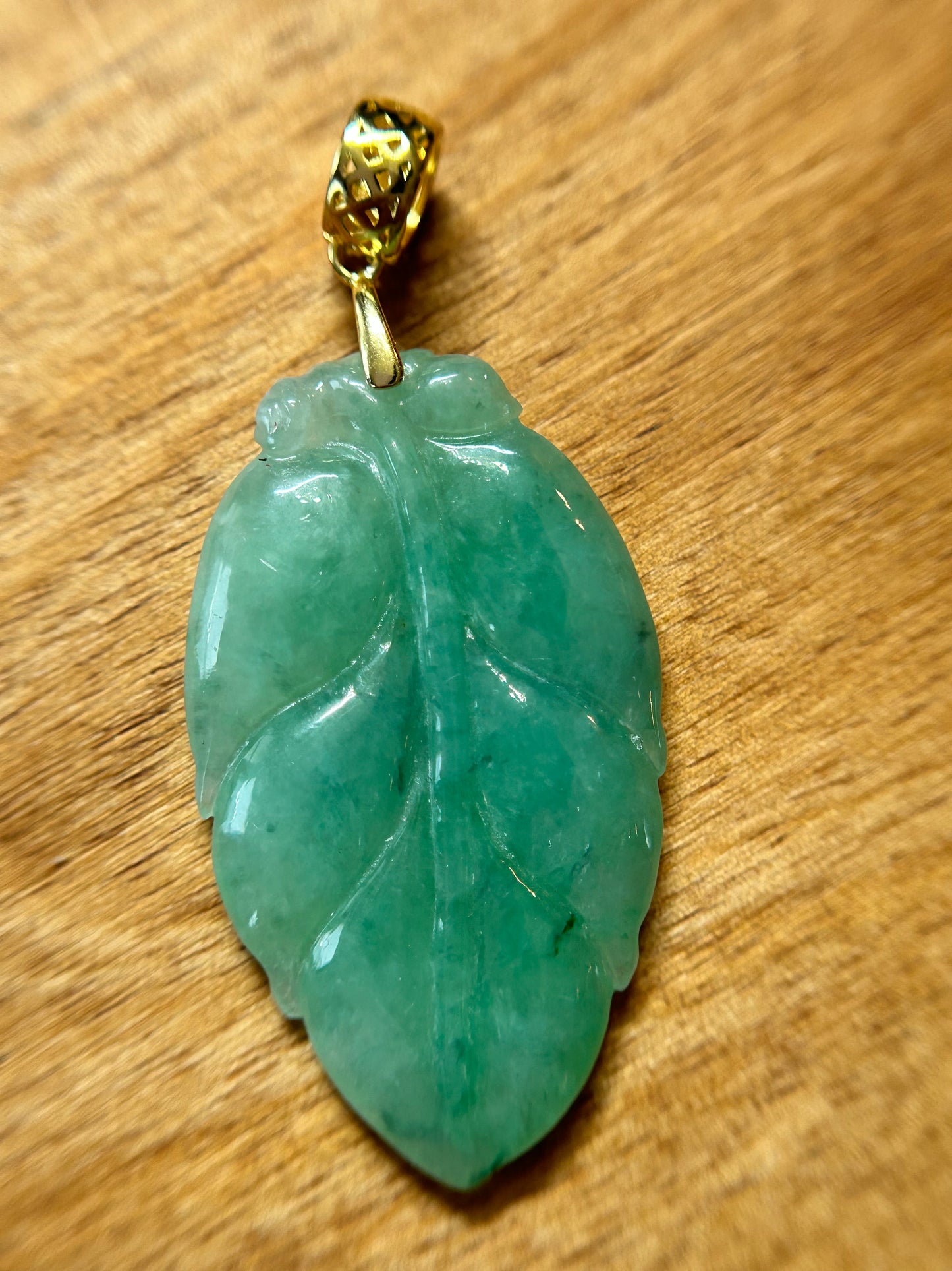 Grade A Natural Icy green Burma Jadeite pendant with double sided hand carved with leaf gold over sterling silver bail pendant