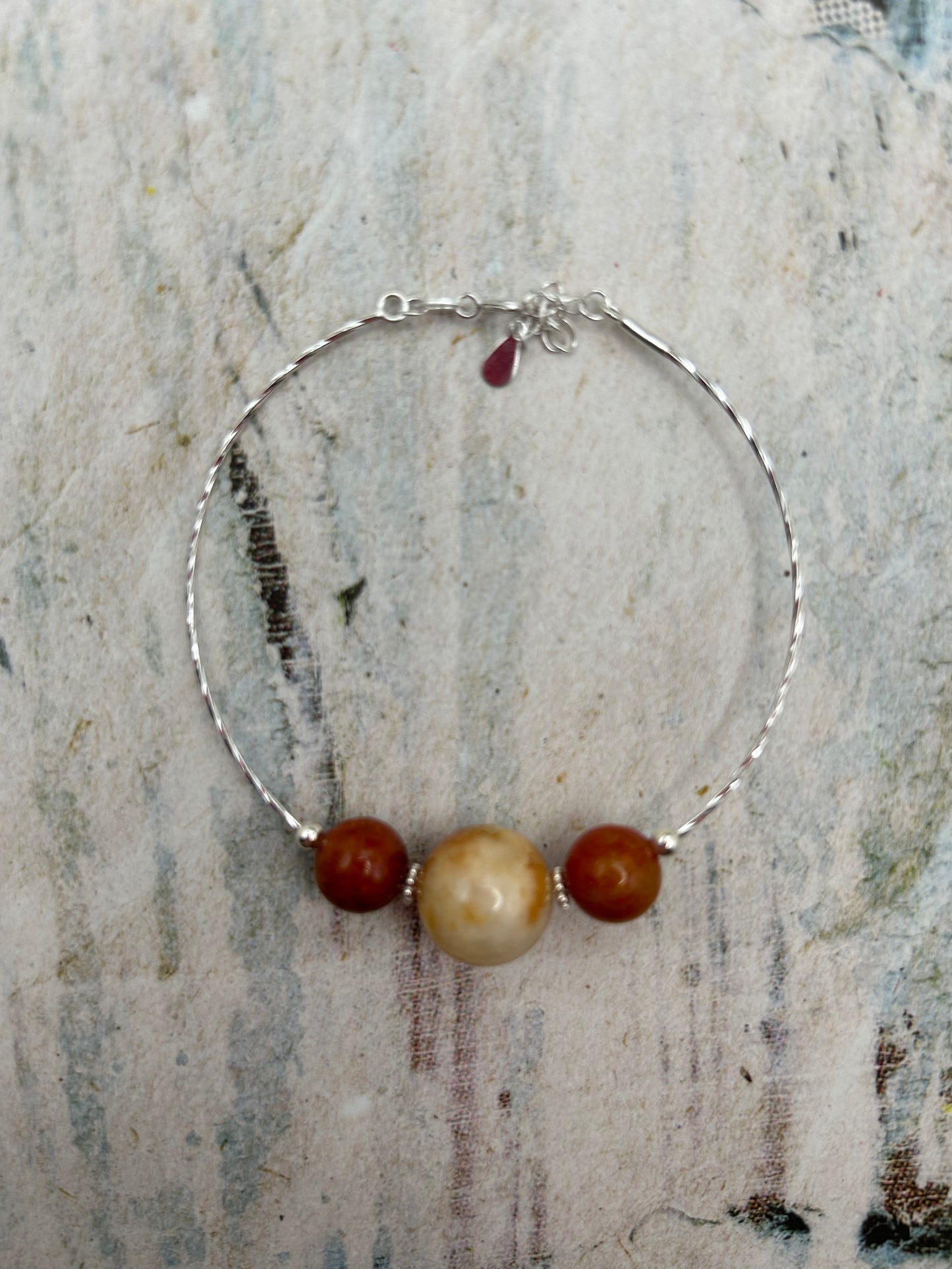 Grade A Natural Beige and Red Burmese Jadeite beads on a sterling silver bracelet