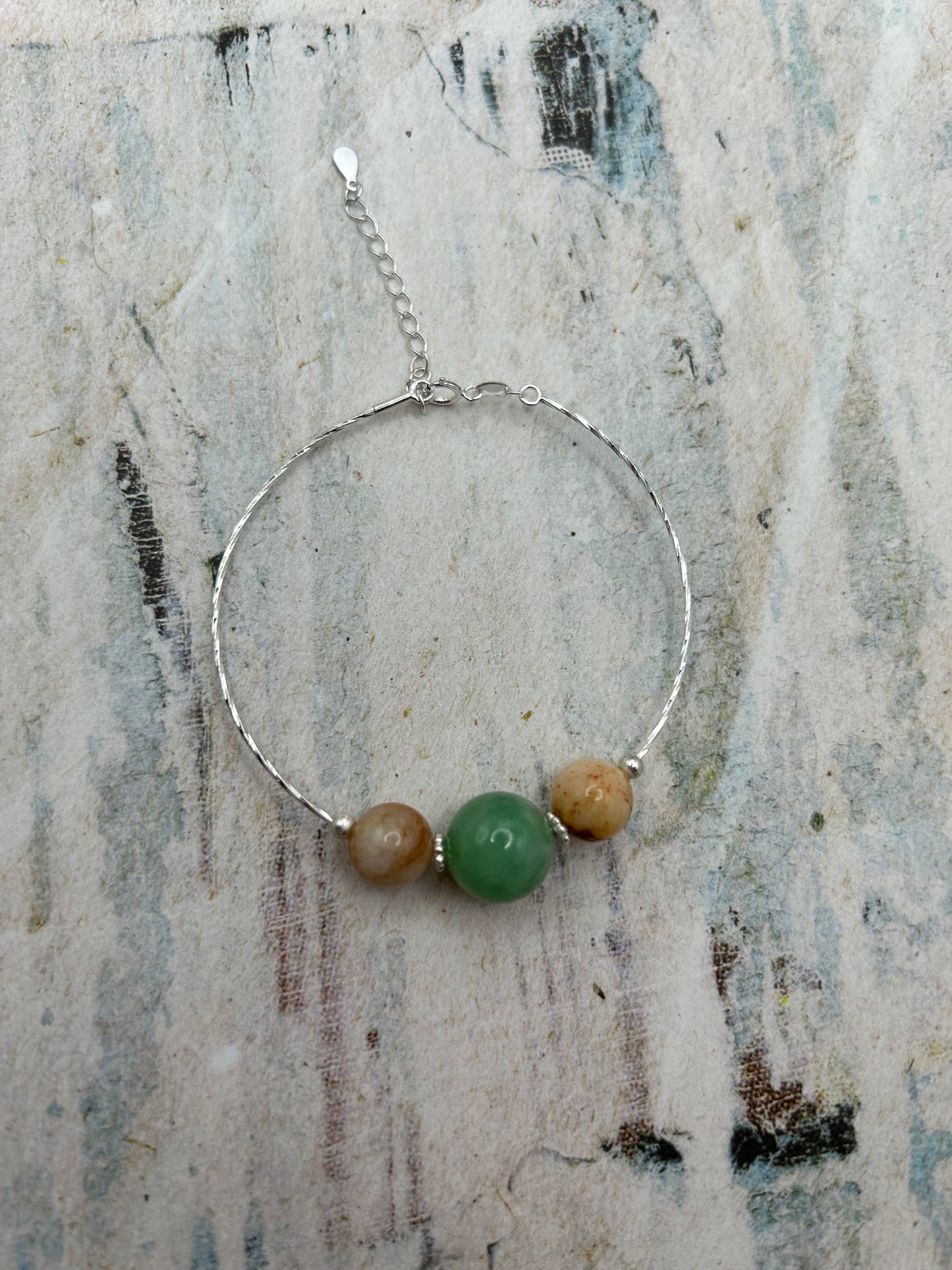 Grade A Natural green and Beige Burmese Jadeite beads on a sterling silver bracelet