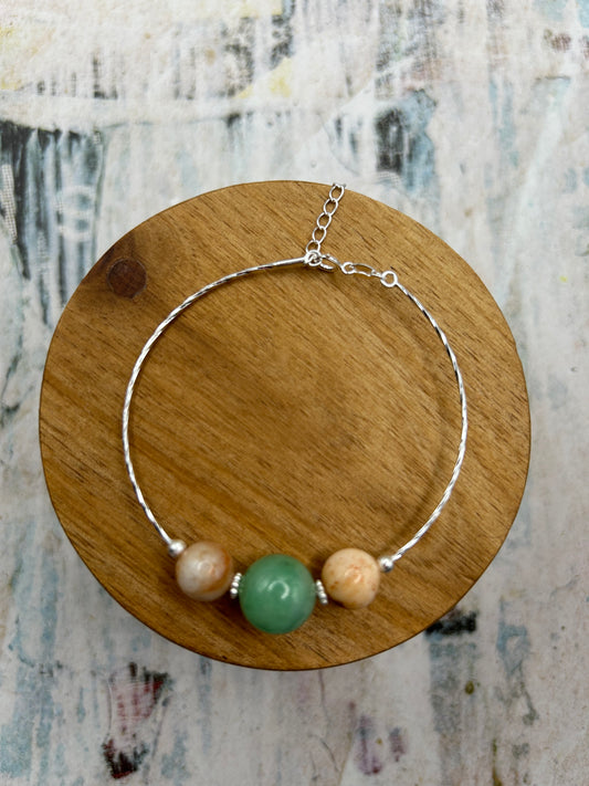 Grade A Natural green and Beige Burmese Jadeite beads on a sterling silver bracelet