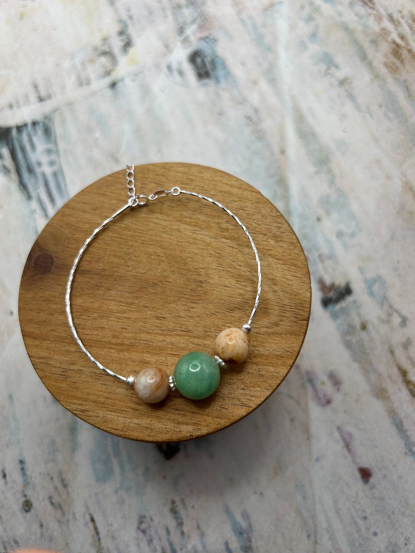 Grade A Natural green and Beige Burmese Jadeite beads on a sterling silver bracelet