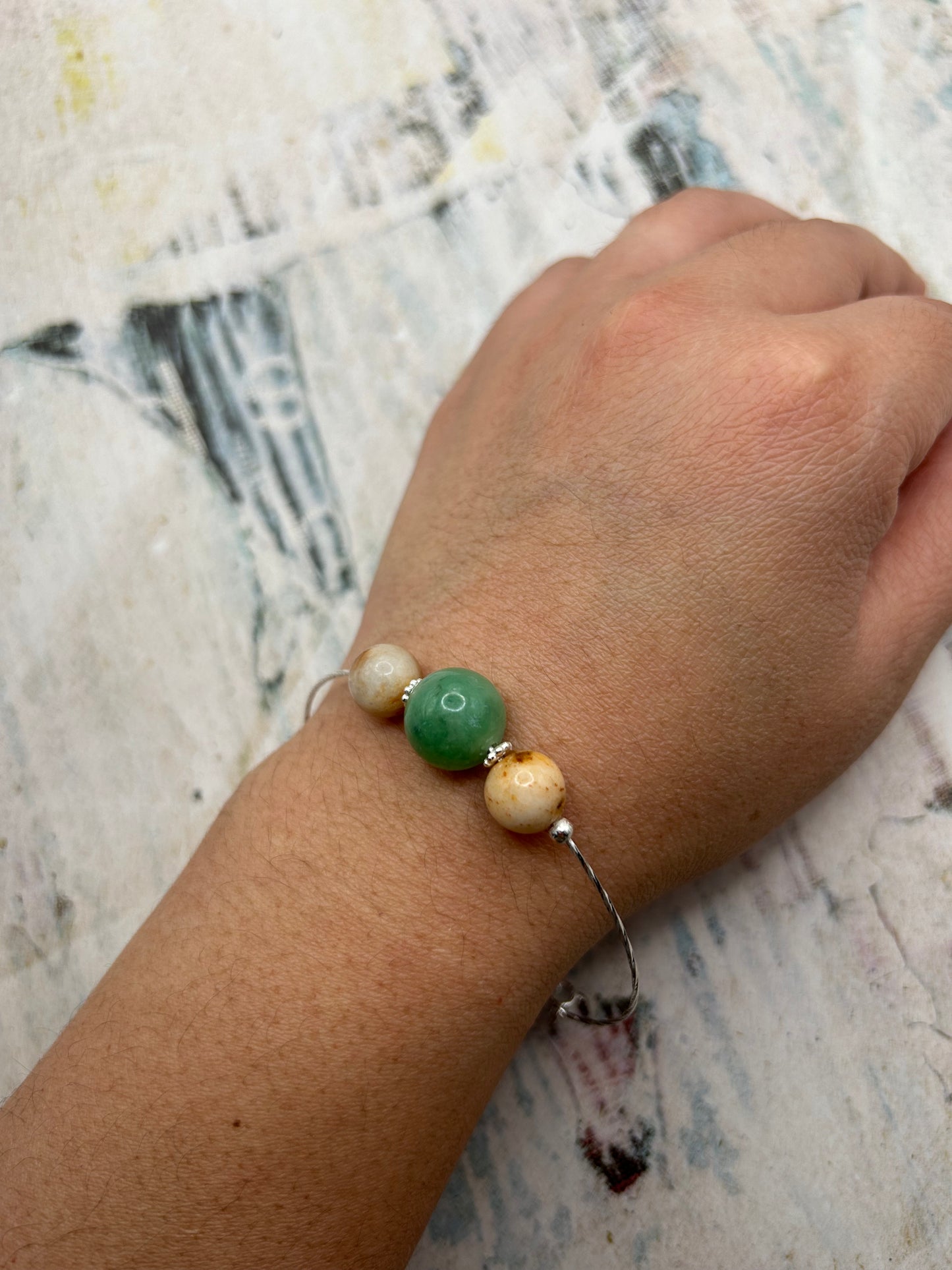 Grade A Natural green and Beige Burmese Jadeite beads on a sterling silver bracelet