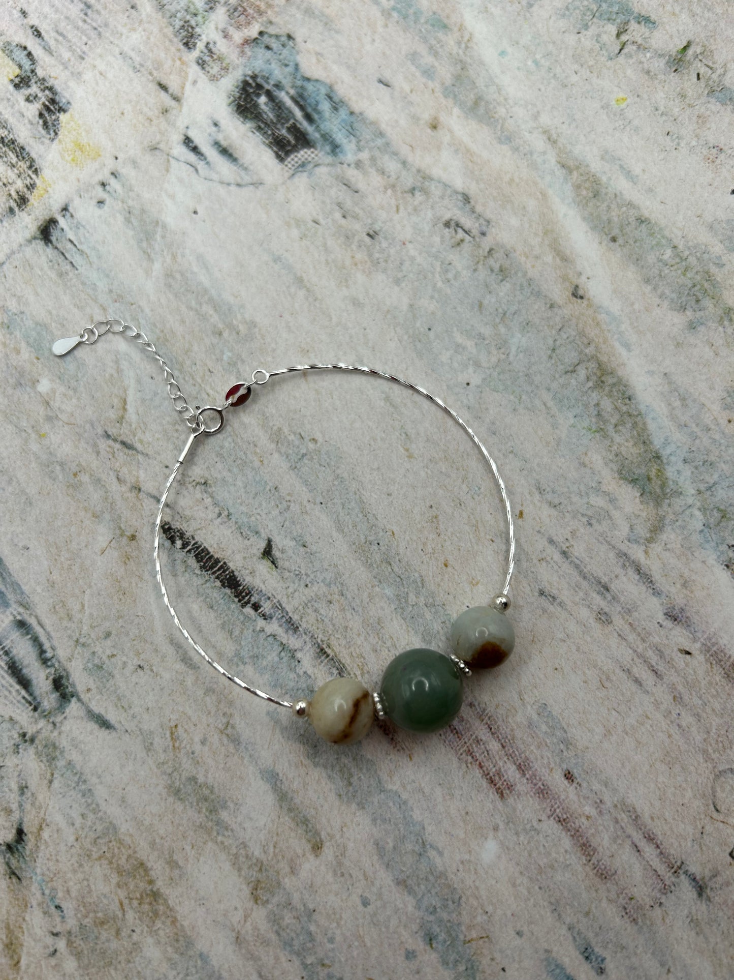 Grade A Natural Green and Beige Burmese Jadeite beads on a sterling silver bracelet