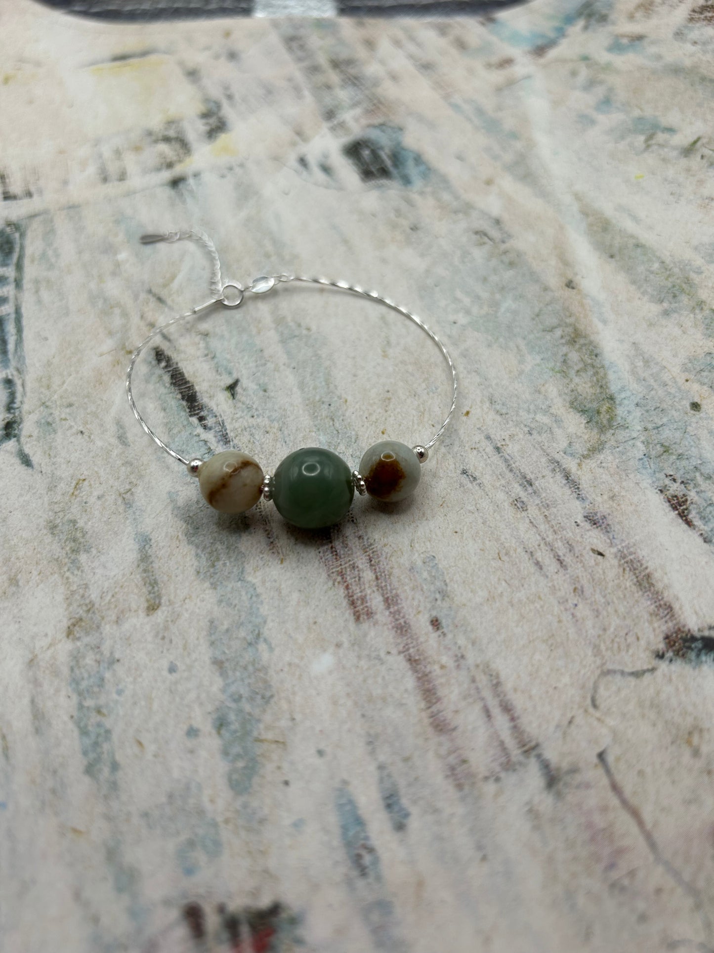 Grade A Natural Green and Beige Burmese Jadeite beads on a sterling silver bracelet