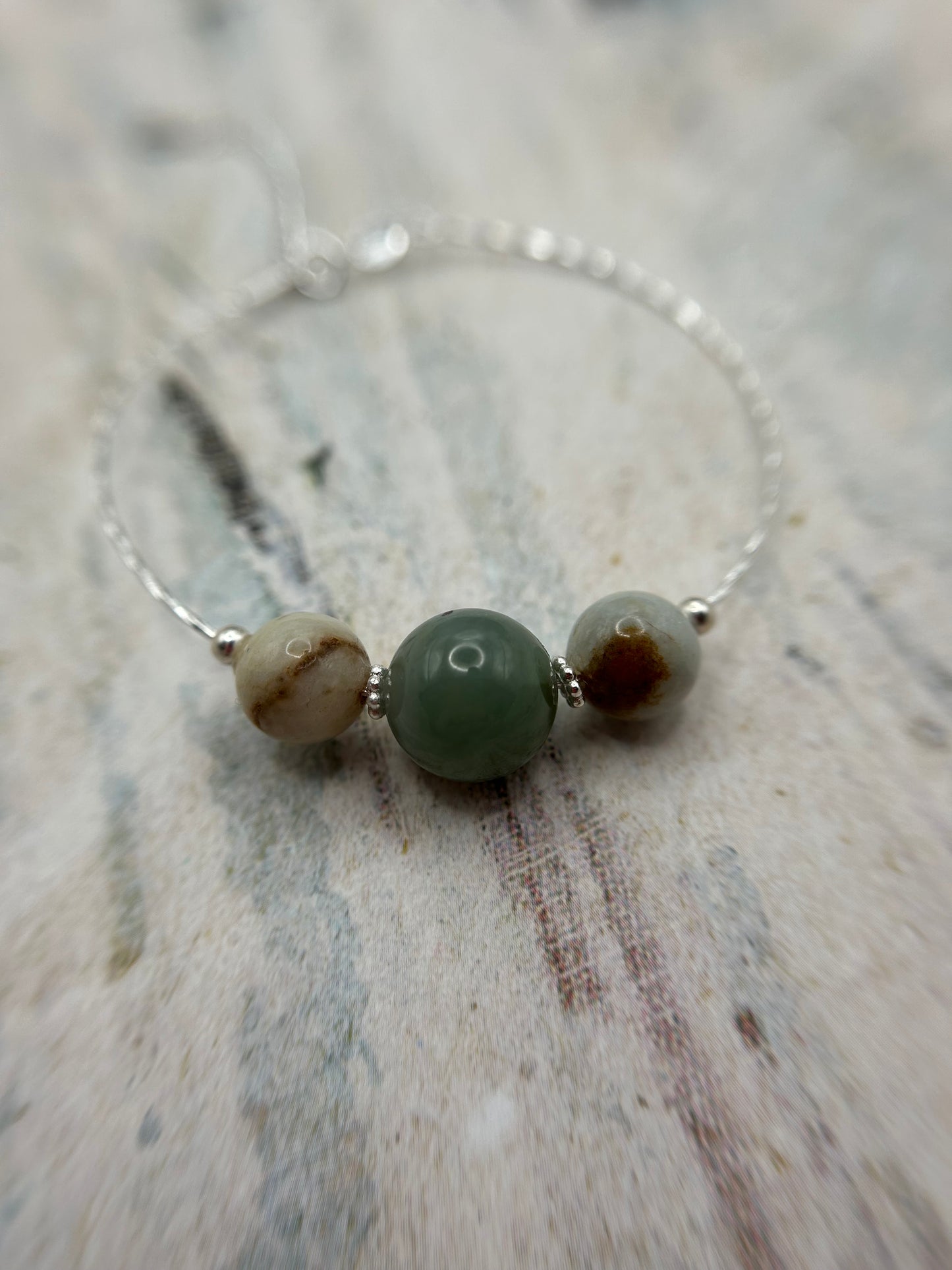 Grade A Natural Green and Beige Burmese Jadeite beads on a sterling silver bracelet