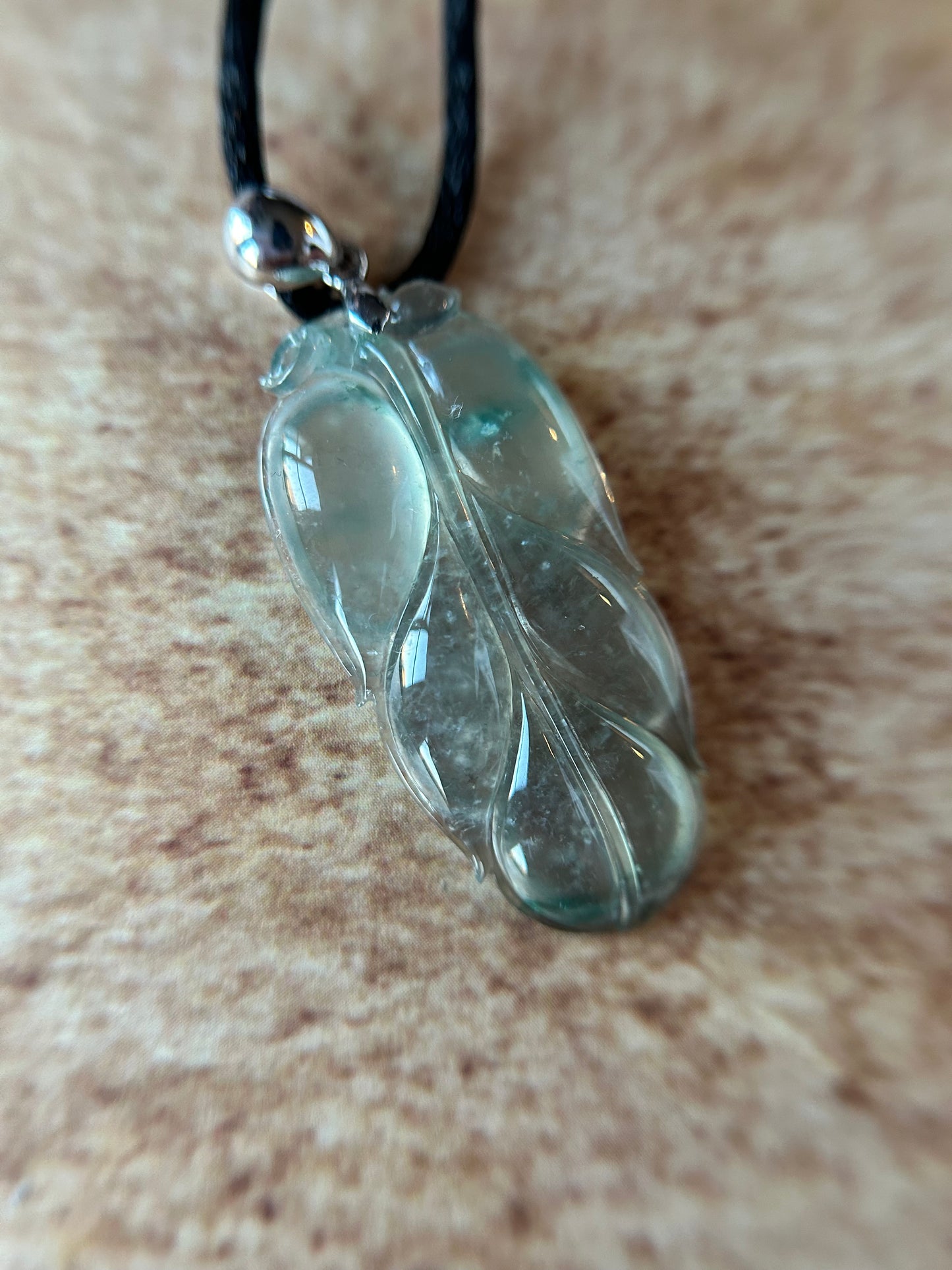 Natural glassy pale green with dark green patches leaf pendant on 18k white gold bail. trusted lab certificate included