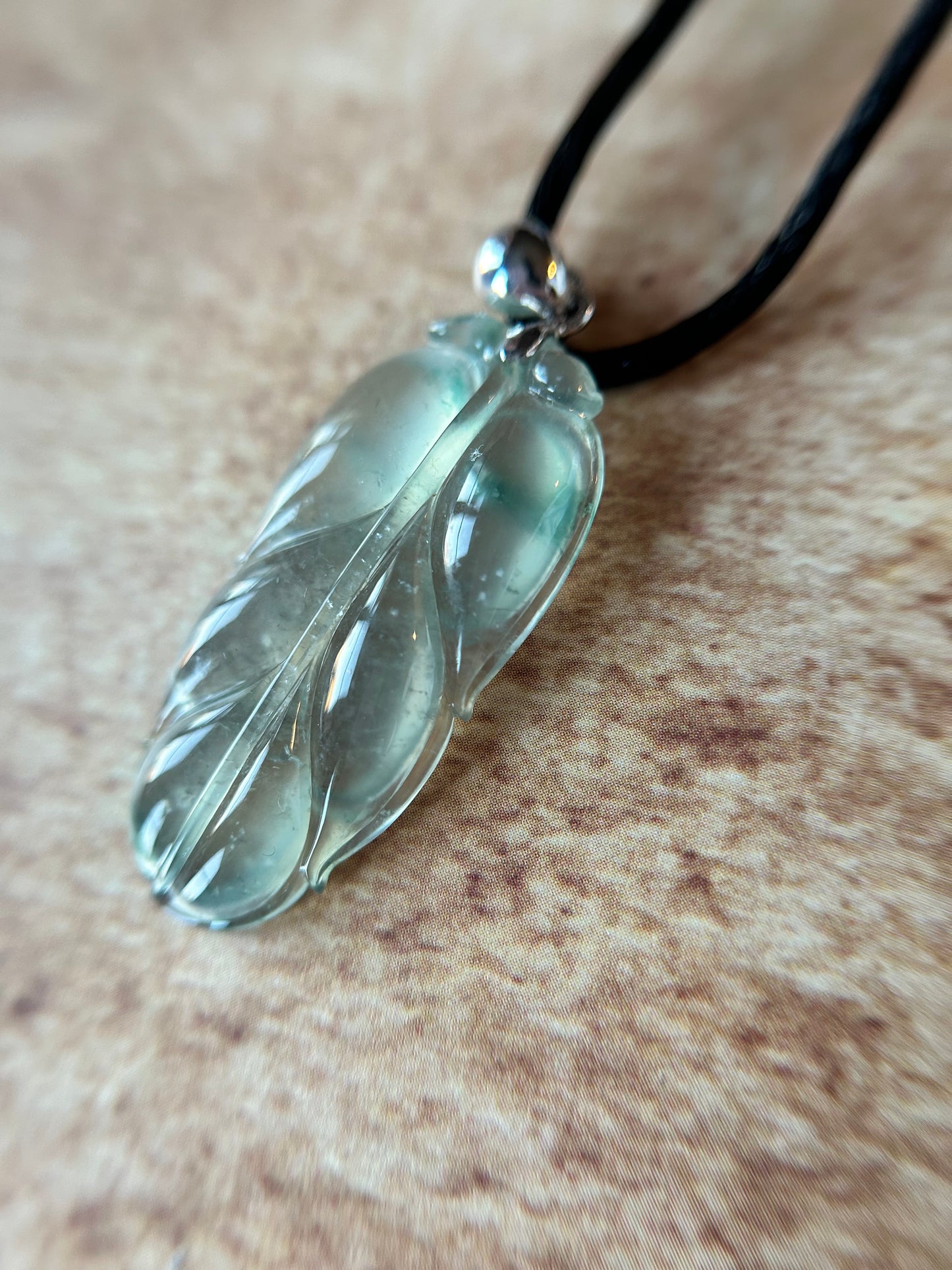 Natural glassy pale green with dark green patches leaf pendant on 18k white gold bail. trusted lab certificate included