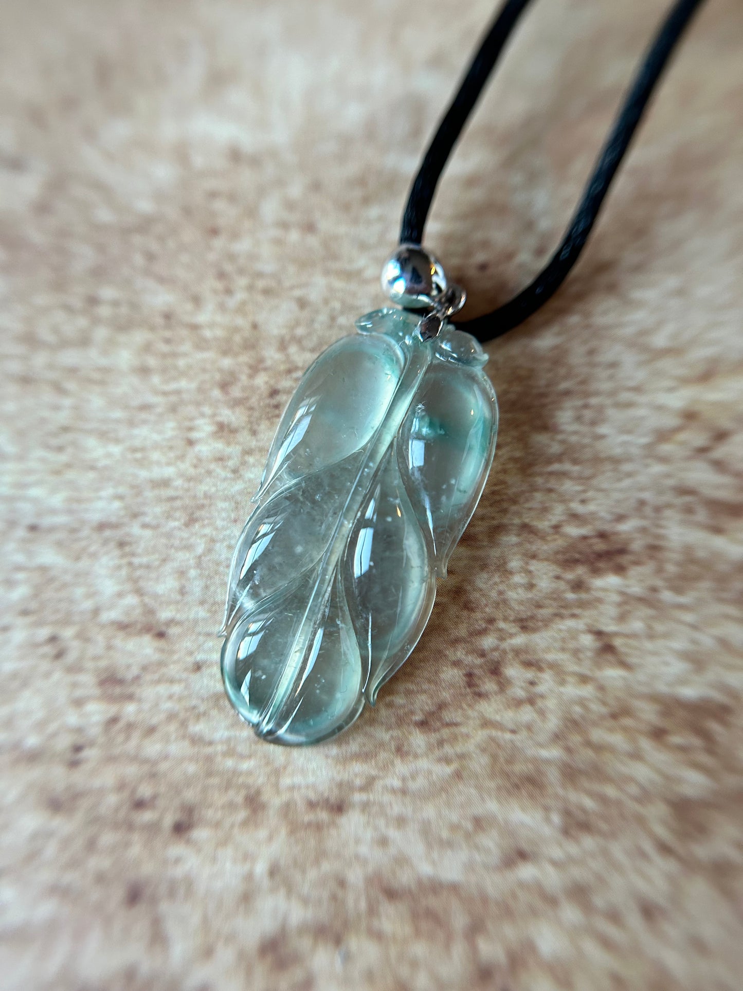 Natural glassy pale green with dark green patches leaf pendant on 18k white gold bail. trusted lab certificate included