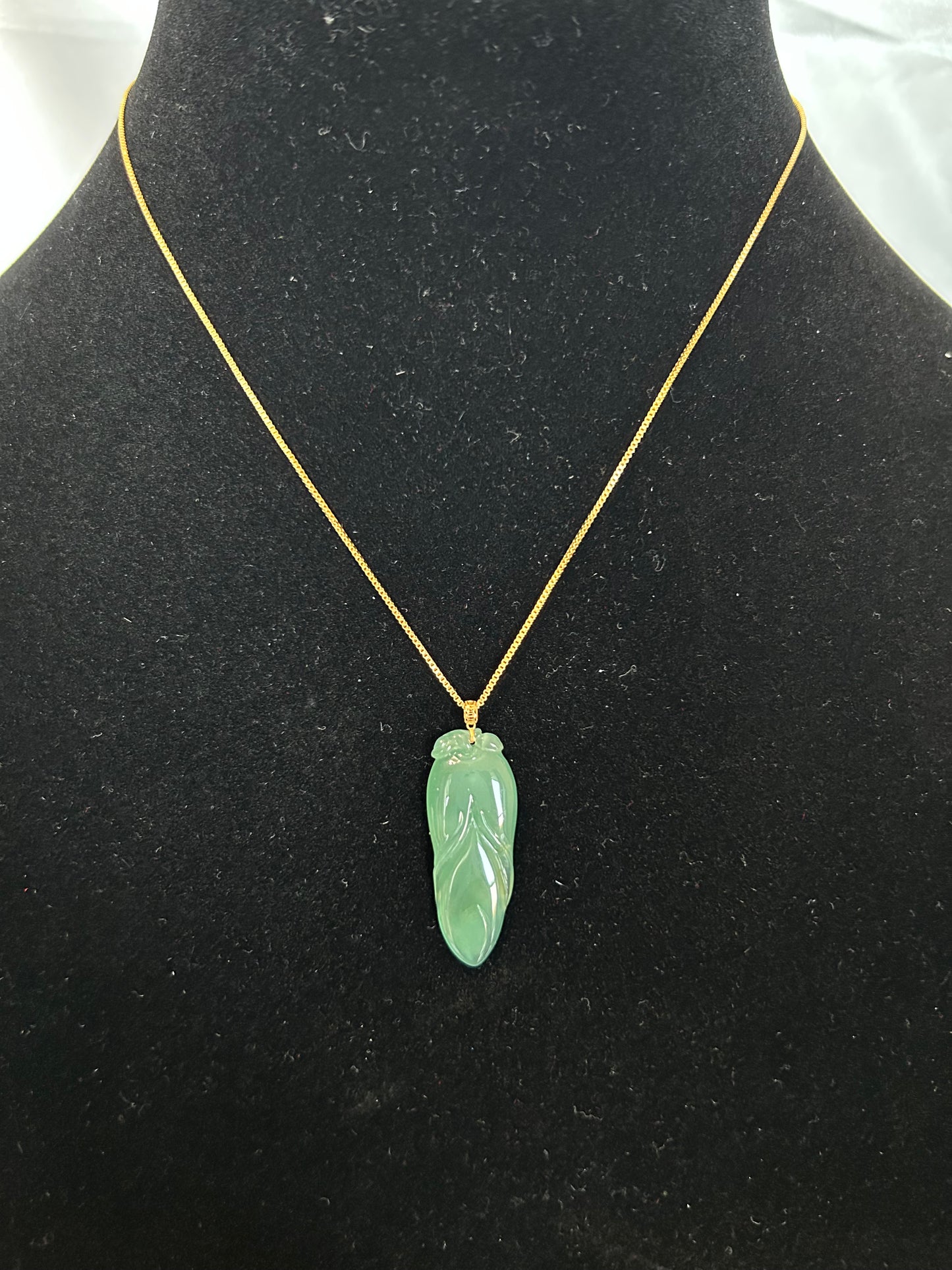 Natural icy green jadeite leaf pendant with 14K yellow gold bail