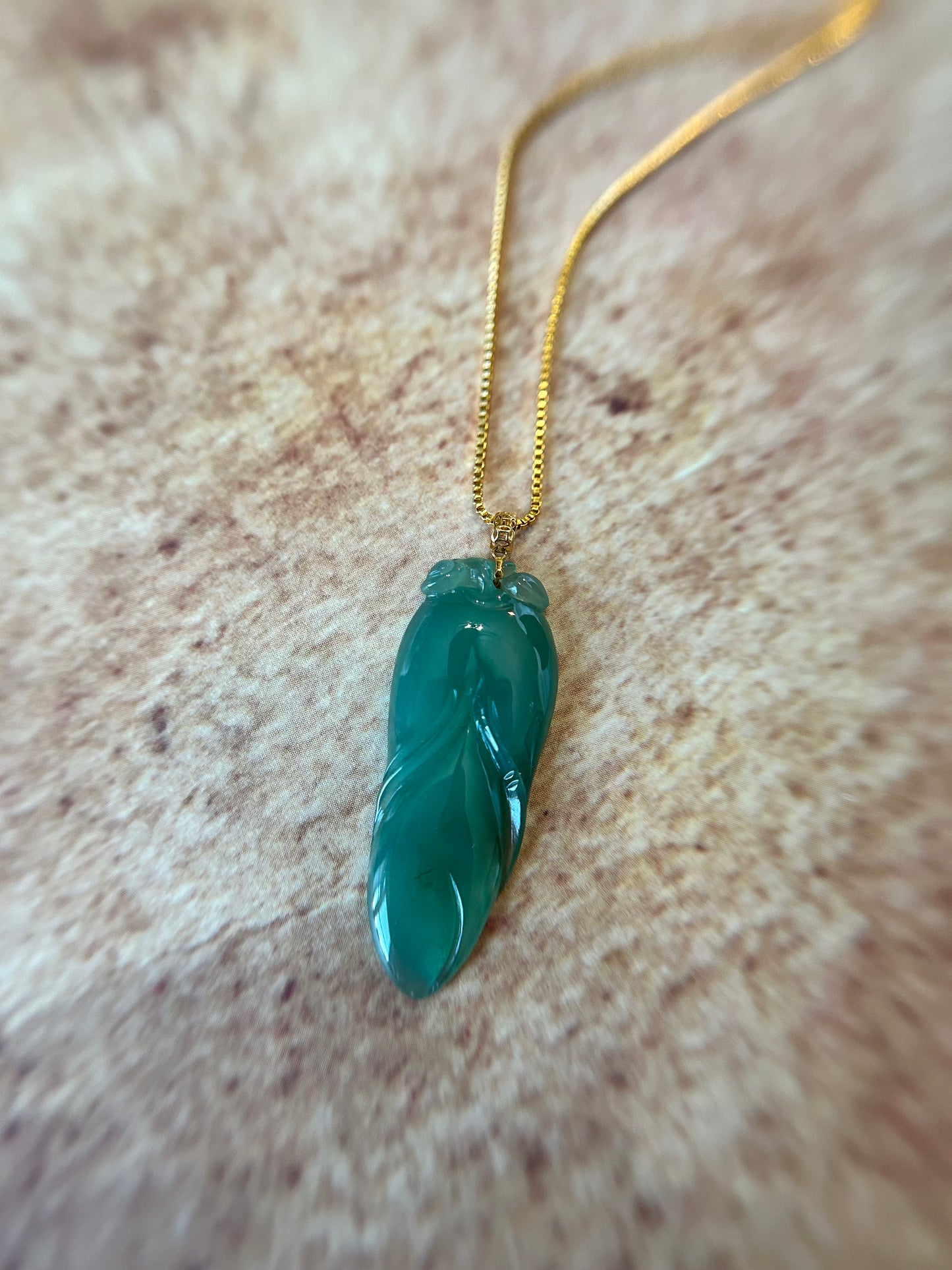 Natural icy green jadeite leaf pendant with 14K yellow gold bail