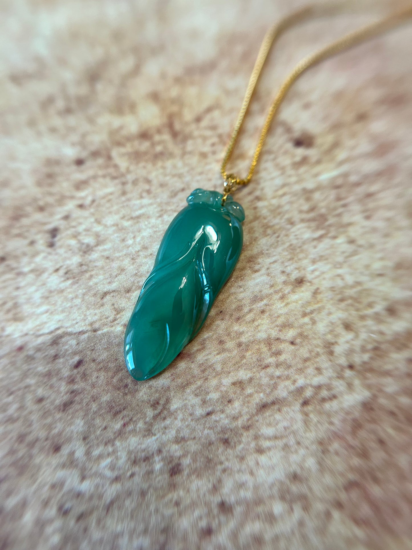 Natural icy green jadeite leaf pendant with 14K yellow gold bail