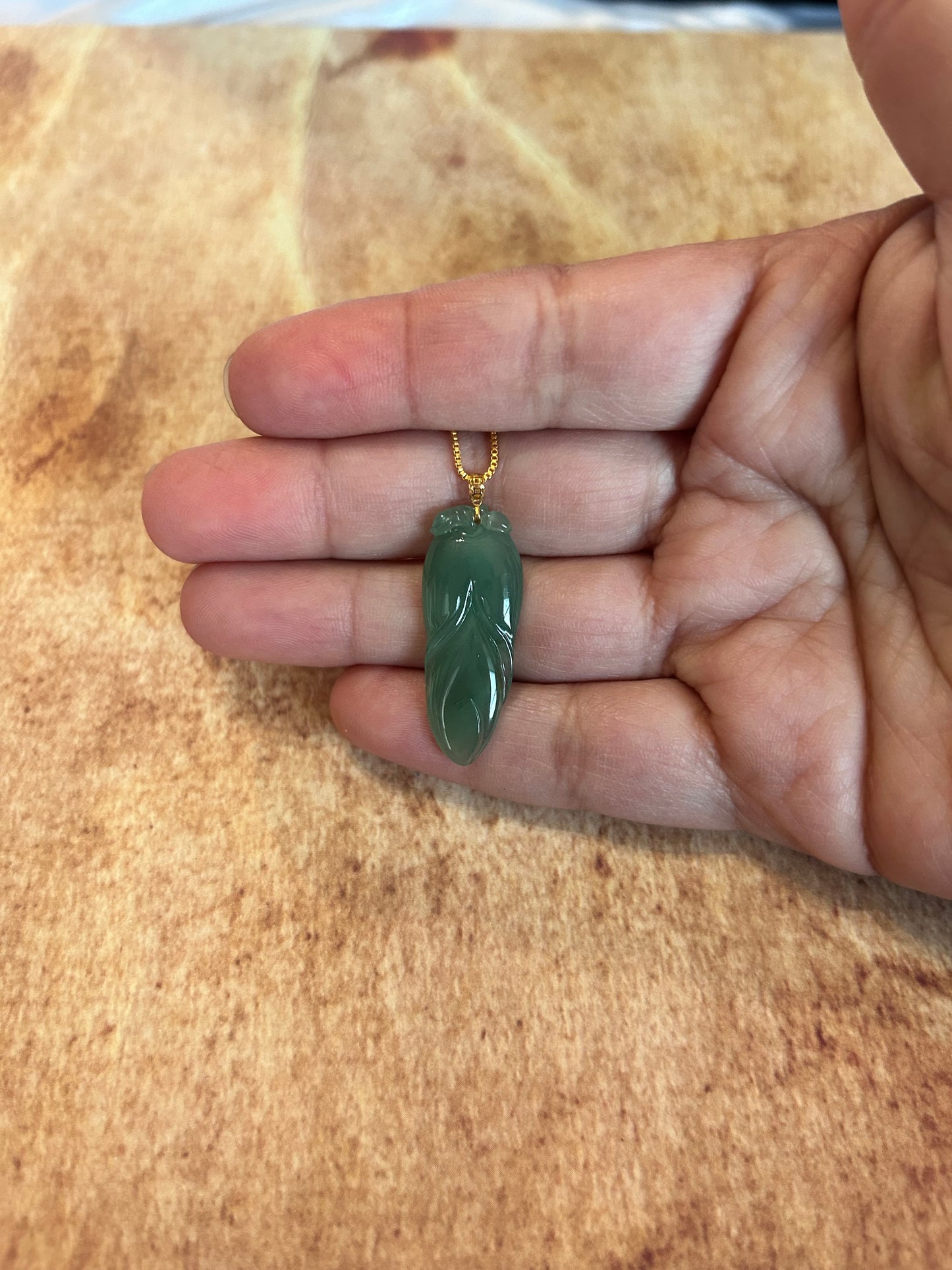 Natural icy green jadeite leaf pendant with 14K yellow gold bail