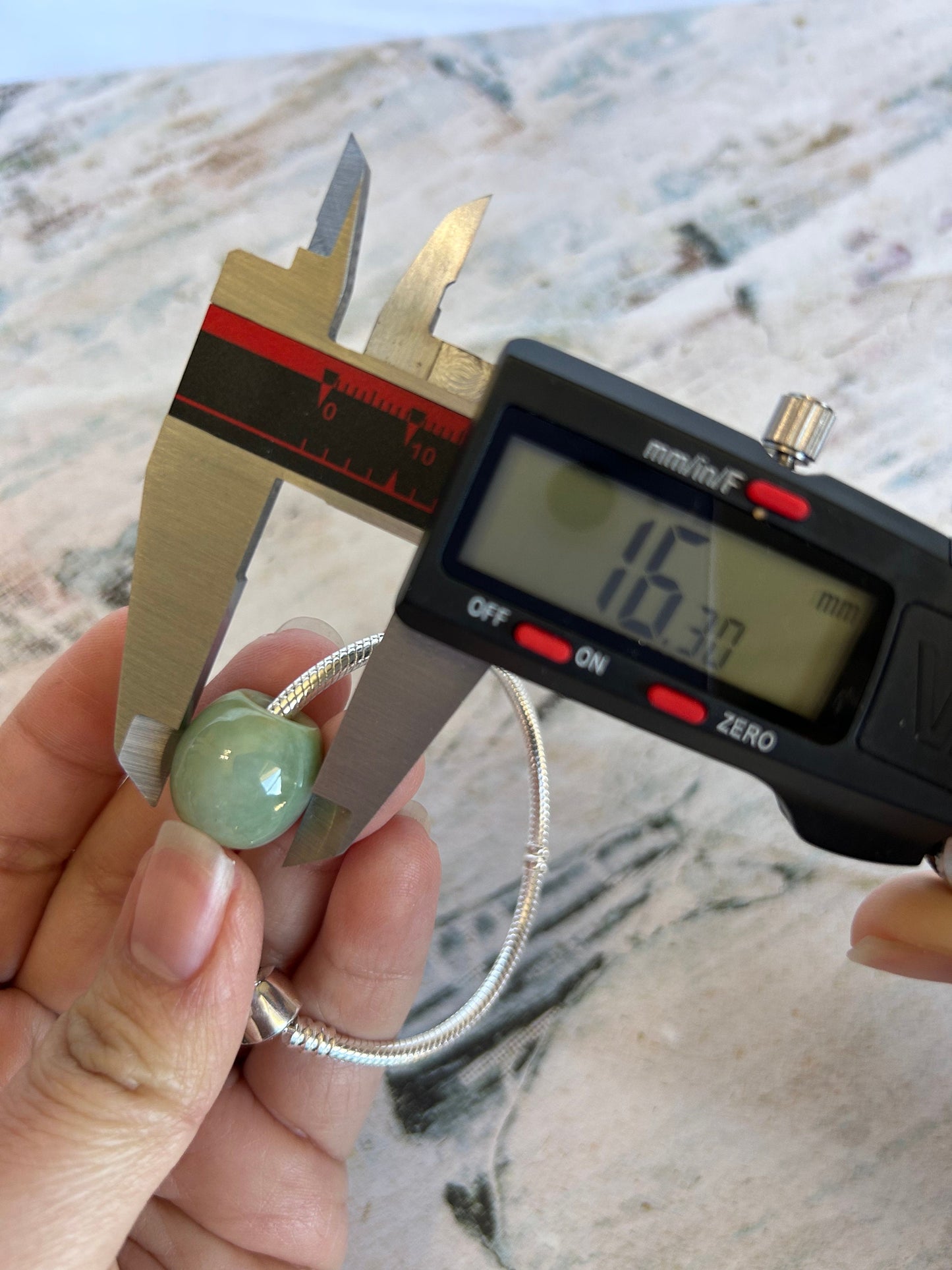 Grade A Natural Green and Yellow Burmese Jadeite Lu Lu Tong charm on a sterling silver bracelet